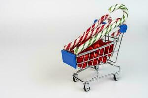 A supermarket trolley loaded with candies and Christmas caramel canes photo