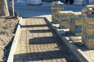 stacks of paving slabs for paving paths stacked on a construction site photo