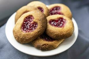 Homemade cookies decorated with raspberry jam in the shape of a heart photo