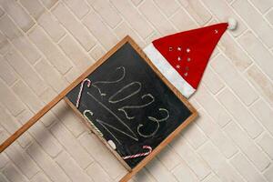 a black slate on which the year 2023 is written in chalk. Happy New Year. photo