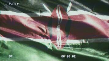 VHS video casette record Kenya flag waving on the wind. Glitch noise with time counter recording Kenyan banner swaying on the breeze. Seamless loop.