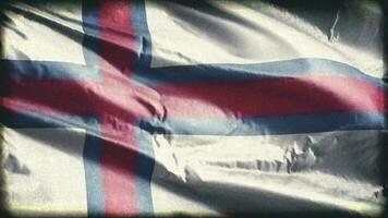 Retro aged Faroe Island flag waving on the wind. Old vintage banner swaying on the breeze. Seamless loop. video