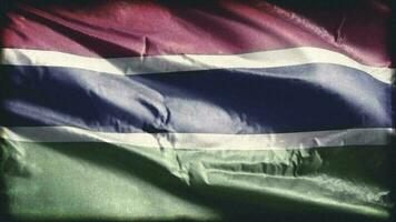 Retro aged Gambia flag waving on the wind. Old vintage Gambian banner swaying on the breeze. Seamless loop. video