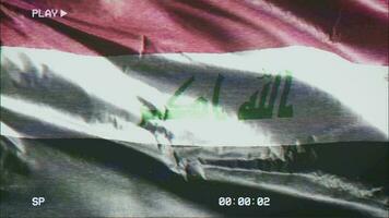 VHS video casette record Iraq flag waving on the wind. Glitch noise with time counter recording Iraqi banner swaying on the breeze. Seamless loop.