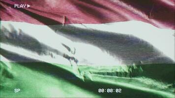 VHS video casette record Hungary flag waving on the wind. Glitch noise with time counter recording banner swaying on the breeze. Seamless loop.