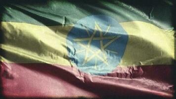 retro envelhecido Etiópia bandeira acenando em a vento. velho vintage etíope bandeira balançando em a brisa. desatado laço. video