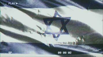 VHS video casette record Israel flag waving on the wind. Glitch noise with time counter recording Israeli banner swaying on the breeze. Seamless loop.