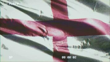 VHS video casette record England flag waving on the wind. Glitch noise with time counter recording banner swaying on the breeze. Seamless loop.