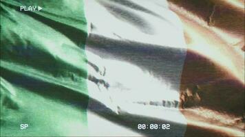 VHS video casette record Ireland flag waving on the wind. Glitch noise with time counter recording Irish banner swaying on the breeze. Seamless loop.