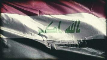 Retro aged Iraq flag waving on the wind. Old vintage Iraqi banner swaying on the breeze. Seamless loop. video