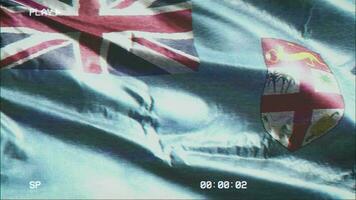 VHS video casette record Fiji flag waving on the wind. Glitch noise with time counter recording banner swaying on the breeze. Seamless loop.