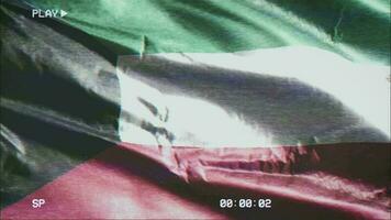 VHS video casette record Kuwait flag waving on the wind. Glitch noise with time counter recording Kuwaiti banner swaying on the breeze. Seamless loop.