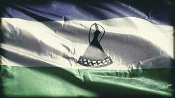 Retro aged Lesotho flag waving on the wind. Old vintage banner swaying on the breeze. Seamless loop. video