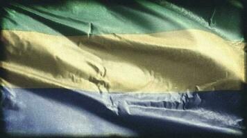 Retro aged Gabon flag waving on the wind. Old vintage Gabonese banner swaying on the breeze. Seamless loop. video