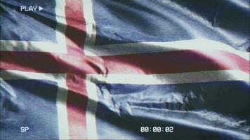 VHS video casette record Iceland flag waving on the wind. Glitch noise with time counter recording banner swaying on the breeze. Seamless loop.