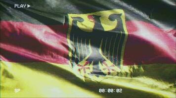 VHS video casette record Germany flag waving on the wind. Glitch noise with time counter recording German banner swaying on the breeze. Seamless loop.