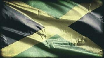 Retro aged Jamaica flag waving on the wind. Old vintage Jamaican banner swaying on the breeze. Seamless loop. video