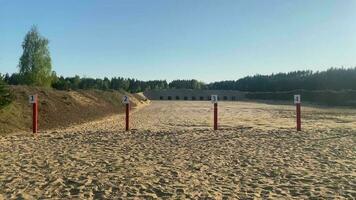 Close up view shooting exercise zone area in baltics with numbered targets. Soldiers aiming posts surrounded by forest woods isolated secret location video