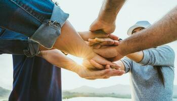 People putting their hands together. Friends with a stack of hands showing unity and teamwork. Friendship happiness leisure partnership team concept. photo