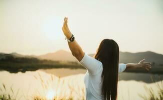 Happy woman spreading arms and watching the mountain. Travel Lifestyle success concept adventure active vacations outdoor freedom emotions. photo