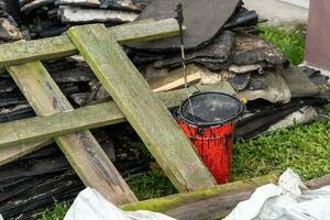 debris left after the repair of the roof. red bucket with mastic photo