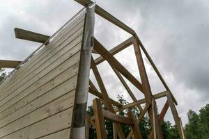 construction of a frame house. Timber frame house, new build roof photo