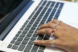 beautiful female hands are typing on a laptop.Remote work on computer photo