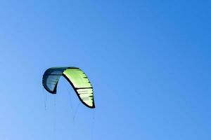 wing of kitesurfing against the blue sky . Kitesurfing on the sea photo