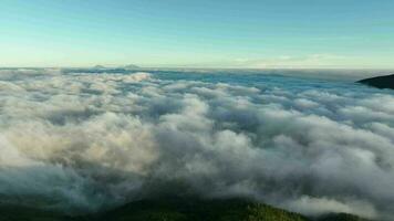 Aerial View Above Clouds and Mountains at Sunrise video