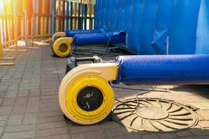 a blower for inflating a large trampoline in the park photo