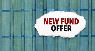 Text new fund offer on the piece of paper on the green wood background photo