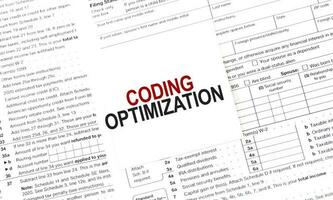 CODING OPTIMIZATION on white sticker and papers photo
