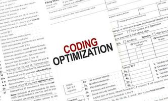 CODING OPTIMIZATION on white sticker and papers photo