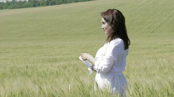 Young lady in the middle of the wheat field video