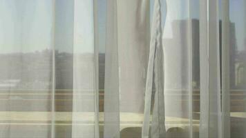 White transparent voile at the window. City scape behind the curtain video