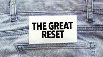 Text THE GREAT RESET on a white paper stuck out from jeans pocket. Business concept photo