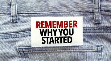 Text remember why you started on a white paper stuck out from jeans pocket. Business concept photo