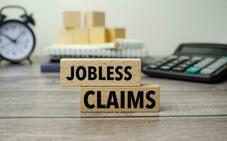 JOBLESS CLAIMS is shown on a conceptual photo using wooden blocks