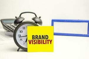 Retro alarm clock and the text brand visibility word photo