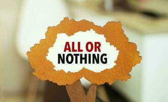 figure of a tree with text ALL OR NOTHING inside the foliage. Business concept photo
