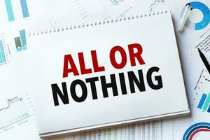 Notebook with Tools and Notes with text ALL OR NOTHING photo