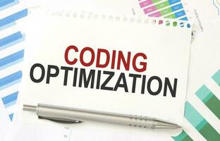 CODING OPTIMIZATION on white paper with colourful charts photo