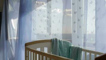 Empty baby boy room. Blue transparent curtains at decorated window in the background video