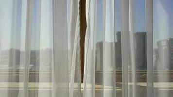 White transparent voile at the window. City scape behind the curtain video