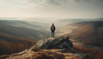 One person hiking to mountain peak, backpack standing on rock generated by AI photo