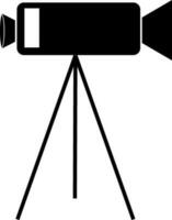 Black video camera on tripod. vector