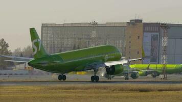 NOVOSIBIRSK, RUSSIAN FEDERATION OCTOBER 20, 2021 - S7 passenger jet landing and braking at Tolmachevo airport OVB video