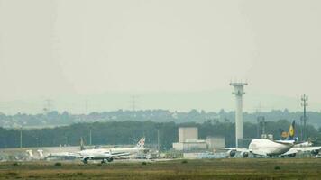 FRANKFURT AM MAIN, GERMANY JULY 17, 2017 - Panoramic view of the airfield at Frankfurt Airport, Germany. Commercial Lufthansa aircraft on the runway. Jumbo jet in the background. Travel concept video