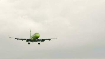 NOVOSIBIRSK, RUSSIAN FEDERATION JULY 15, 2022 - Civil plane of S7 Airlines approaching before landing, side view. Airplane in the cloudy sky. Tourism and travel concept video