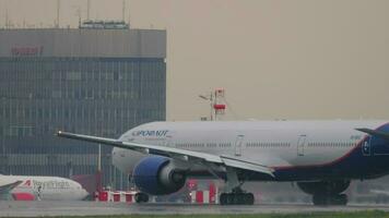 MOSCOW, RUSSIAN FEDERATION JULY 29, 2021 - Boeing 777, VQ BUC of Aeroflot departure at Sheremetyevo airport SVO. Passenger plane speed up before takeoff. Spray, aircraft landing gear, rain video